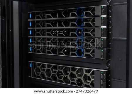 High-density server rack in a data center with modern network equipment and blue status lights