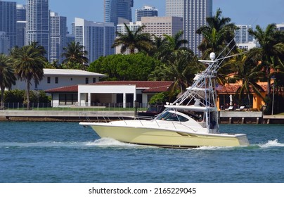 High-end fishing boat equipped with tuna tower cruising. by DeLido Island,``Miami Beach,on the Intra-Coastal Waterway with `downtown Miami's tall building skyline in the background .