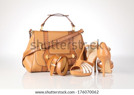 high-heeled boots and leather bag