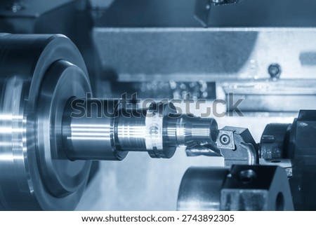 The high-level Process Integration of a modern Multi-tasking (Mill-Turn) Machining Center. The focus is on the finishing pass of a cylindrical alloy steel shaft, where the machine utilizes simultaneous axis control to achieve exacting dimensional tolerances and a superior surface finish.