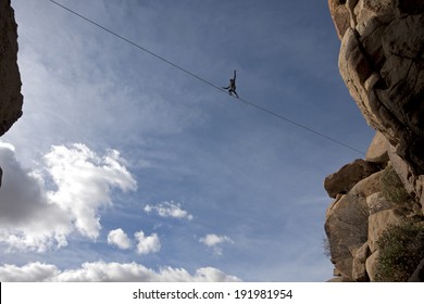 Highline walker in blue sky, Joshua Tree National Park