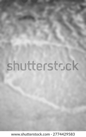 A highly blurred, monochromatic microscopic view of organic cellular tissue, showcasing abstract biological patterns and delicate, translucent structures commonly observed in histological research.