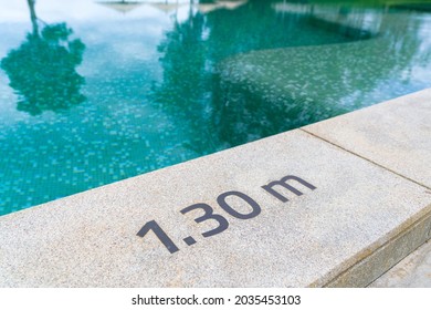 Highly Durable Depth Number Message Safety Sign On Exposed Aggregate Finish Concrete Deck Floor Allowing Outdoor Swimming Pool To Comply Government Regulations And Requirements