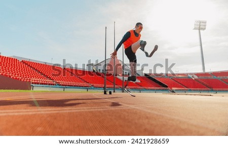 Highly motivated handsome caucasian sporty handicapped man in sportswear and with artificial leg stretching before running while standing on the racetrack. Sport Concept, Inspiration Concept, Copy Spa