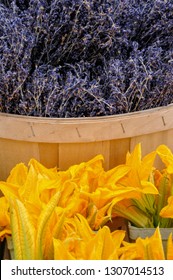 Highly Prized As Edible Flowers, A Bushel Of Freshly Cut Organic Culinary Lavender Sits Alongside Fresh Zucchini Blossoms At A Local Urban Farmer's Market.  