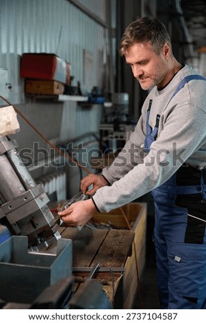 Highly skilled man worker constructing PVC windows in factory