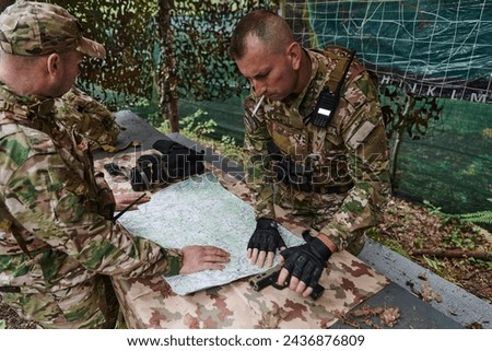 A highly trained military unit strategizes and organizes a tactical mission while studying a military map during a briefing session