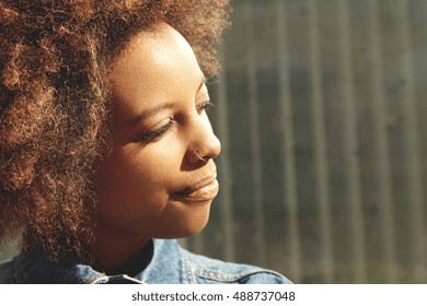 Highly-detailed Shot Of Beautiful Happy African Female With Healthy Perfect Skin And Facial Piercing, Looking Away With Closed Eyes. Young Black Student Girl Having Nice Walk After Classes At College