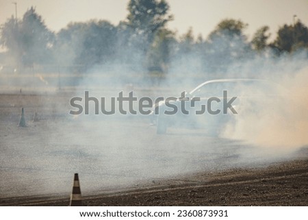 High-octane car drift race captured amidst swirling smoke, showcasing speed and skill.