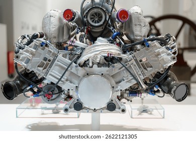 A high-performance engine is showcased prominently, featuring sleek metallic components and intricate details. Visitors to the museum can admire the advanced technology and engineering.