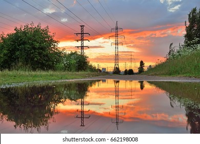 High-power line - power lines and the sunset reflected in the water after the rain - Powered by Shutterstock