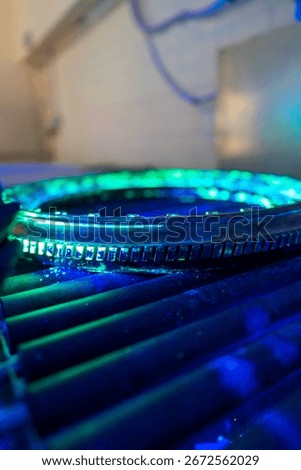 A high-precision aerospace component is undergoing fluorescent penetrant testing with distinctive green indications. Non-destructive evaluation exposes  discontinuities in this critical flight safety 