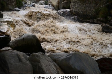 High-pressure flood water in mountain river tributary, caused by global warming, melting glaciers, and torrential rains. This has caused devastation in Pakistan

With selective focus  depth of field. - Shutterstock ID 2196016393