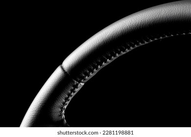 High-quality, detailed photo of a freshly repaired leather steering wheel with a black background and studio lighting. 