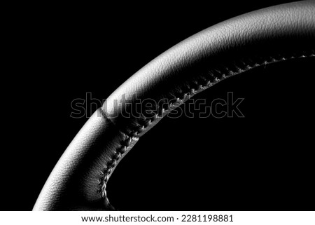 High-quality, detailed photo of a freshly repaired leather steering wheel with a black background and studio lighting. 