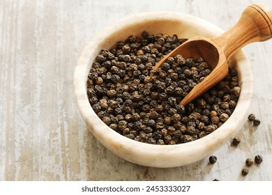 High-quality photo of fresh black pepper. Black pepper is one of the most commonly used kitchen spices worldwide. This dry black pepper is known for its distinctive spicy taste and strong aroma. It is