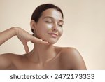 High-quality photo of skincare and cosmetics concept with copy space for text. Natural beauty woman woman with radiant, glowing skin closes her eyes and gently touches her face with her hand, creating