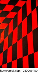 High-Resolution abstract geometric wall pattern featuring bold red and black optical illusion design with diagonal stripes and checkerboard elements. Modern urban mural background with strong perspective, vibrant colors, graphic architecture, and contemporary street art aesthetic. Ideal for backgrounds, wallpapers, textures, branding, posters, and creative design projects.
