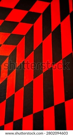 High-Resolution abstract geometric wall pattern featuring bold red and black optical illusion design with diagonal stripes and checkerboard elements. Modern urban mural background with strong perspective, vibrant colors, graphic architecture, and contemporary street art aesthetic. Ideal for backgrounds, wallpapers, textures, branding, posters, and creative design projects.
