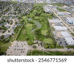 A high-resolution aerial drone photo of Silverwood Heights in Saskatoon, Saskatchewan, showcasing residential homes, parks, tree-lined streets, and scenic views along the South Saskatchewan River.