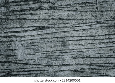 High-resolution background texture of a dark grey concrete surface featuring prominent brushed lines, rough combed cement patterns, and a gritty distressed industrial grunge aesthetic