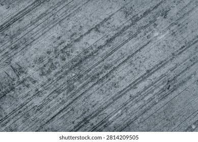 High-resolution background texture of a dark grey concrete surface featuring prominent brushed lines, rough combed cement patterns, and a gritty distressed industrial grunge aesthetic