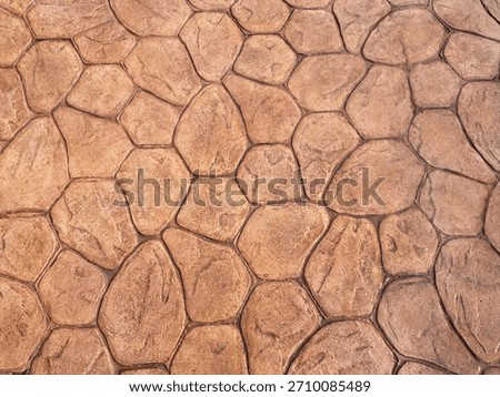 High-resolution brown cobblestone pavement texture featuring an irregular natural rock pattern with a rustic and earthy appearance.