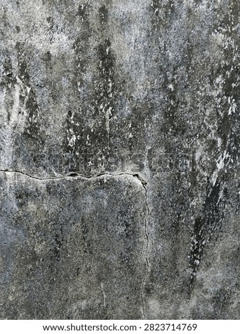A high-resolution close-up of an aged concrete wall featuring natural cracks, weathered textures, peeling surface, and dark stains. The rough cement background showcases an authentic grunge appearance with visible signs of aging, erosion, and deterioration. This detailed abstract texture is ideal for use as a background, wallpaper, graphic design element, construction concept, architectural presentation, or vintage industrial-themed projects. The natural imperfections and distressed surface create a realistic urban backdrop with ample copy space for creative layouts, posters, advertisements, websites, and digital artwork. Perfect for designers seeking authentic concrete, cement, or weathered wall textures with a rustic, worn aesthetic.