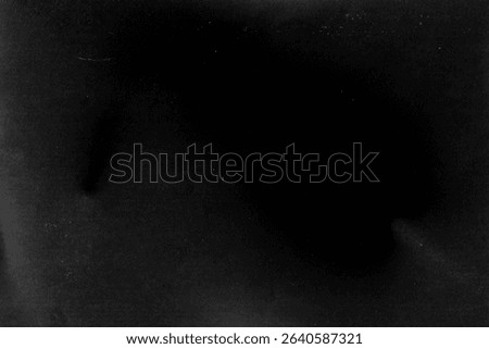 High-resolution flatbed scanner scan on dark monochrome paper. Features subtle variations in gray tones from near-black to lighter shades, with a natural deep center vignette. Real analog scan, no AI, no digital generation. Print-ready at 300dpi, ideal as overlay, background or displacement map for editorial, packaging and poster design.