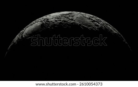 High-resolution image capturing the lunar surface at the edge of dawn, with the sun's light casting subtle shadows across the rugged terrain. photograph showcases the moon's craters. Space dark planet