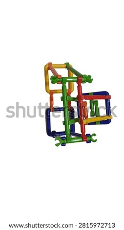 A high-resolution image of colorful plastic building blocks arranged in an intricate geometric structure against a clean white background. The blocks are interlocked to form a complex three-dimensional design that demonstrates engineering principles and problem-solving skills. This is a detailed representation of a modern educational toy designed for children's cognitive development, with vibrant colors and modular components. The composition highlights the playful yet intellectual nature of the product, making it ideal for use in learning environments, science education, or as a STEM-based tool for early childhood development.