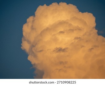 High-resolution image of a storm front during sunset, featuring heavy thunderstorm clouds with vibrant hues on the horizon. Captures weather patterns, meteorological mood, and atmospheric tension.