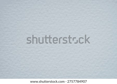 A high-resolution macro shot of white cold-pressed watercolor paper. The image showcases a distinct, heavy-grain textured surface with natural irregularities characteristic of high-quality cotton or pulp paper. The soft lighting emphasizes the professional tooth of the paper, making it ideal for background use or demonstrating art material quality.