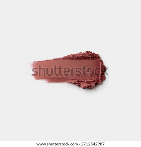 High-resolution makeup smear texture in muted rose-brown shade on a clean white background.