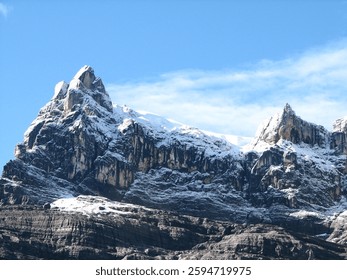 High-resolution photograph capturing the dramatic, snow-covered Carstensz Pyramid (also known as Puncak Jaya) in Papua, Indonesia.