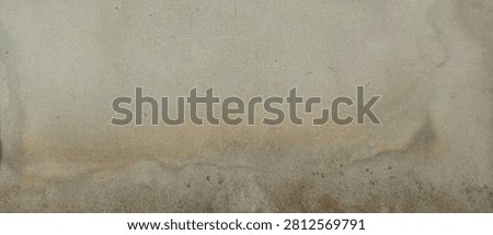 High-resolution texture of a weathered, stained, and damp concrete wall. Features natural water stains, aging spots, and a rough cement surface. Perfect for industrial, grunge, or rustic design backgrounds.