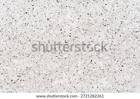 High-resolution view of a white terrazzo surface. Modern stone texture with small grey and brown pebbles, ideal for architectural design and luxury backgrounds
