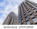 high-rise apartment building against the blue sky. Typical developments in residential areas.