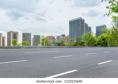 High-rise City Center, Clean Asphalt Road, Lush Park Trees