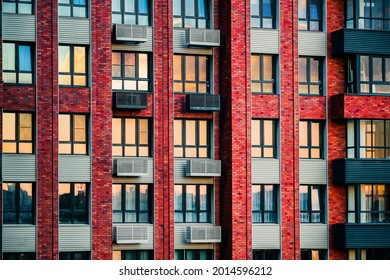 High-rise multi-storey inhabited housing residence in Europe. Stone walls with rows of many windows, balconies, and fan conditioning systems close-up. Reflected sun rays, sunlight and colorful sky. - Shutterstock ID 2014596212