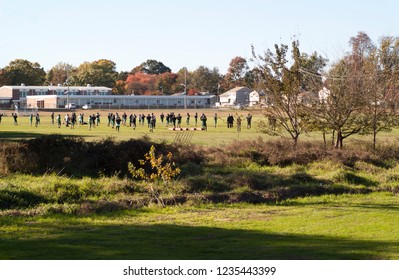 A Highschool Football Team Practices On A Field Adjacent To Spring Lake Park.