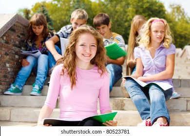 Highschool Students With Books, Sitting On The Stairs