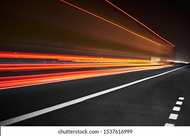 High-speed cars leave behind rays of saturated light. - Shutterstock ID 1537616999