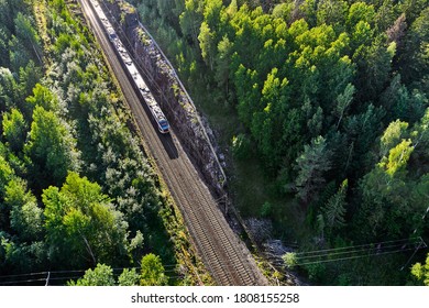 The high-speed commuter train moves on the railroad in the countryside in Espoo, Finland. Aerial view picture. - Powered by Shutterstock