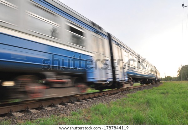 A high-speed diesel train moves quickly by rail.\
Blur, out of focus