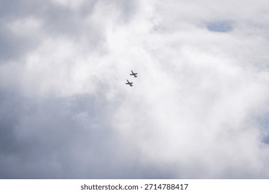 High-speed jets slice through the cloudy sky in perfect formation. This image captures the elegance and precision of aerial maneuvers by military aircraft