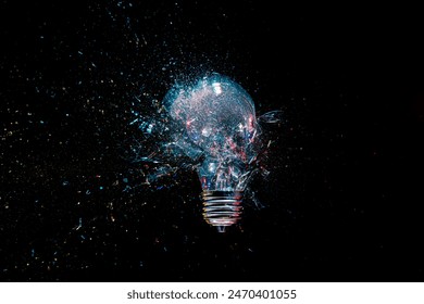 High-speed lightbulb exploding glass shattering black background
