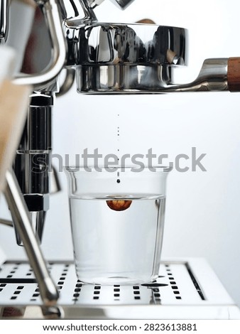 A high-speed macro shot capturing fresh espresso extracting directly into a glass of clear water, creating dynamic liquid swirls. The bottomless portafilter and chrome espresso machine elements emphasize precision barista craftsmanship. Ideal for Americano drink preparation, cafe promo graphics, and specialty coffee visuals.