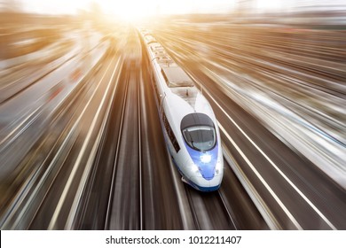 High-speed passenger train travels at high speed. Top view with motion effect, greased background