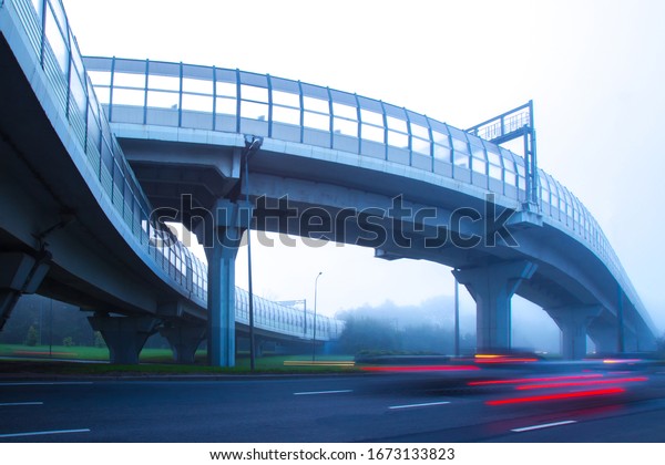 High-speed\
roads with protective screens. Movement of cars in the fog.\
High-speed auto movement in different directions. Organization of\
traffic. Road infrastructure. Road\
junction.